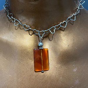Stunning amber necklace with silvertone heart chain